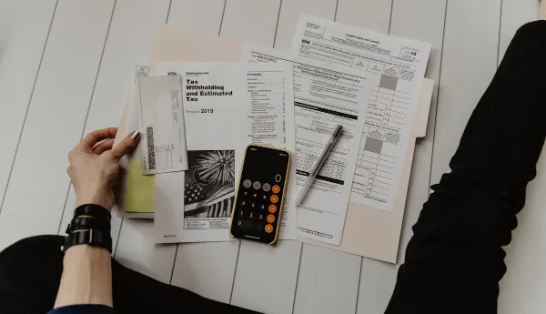 Reviewing tax documents and calculating debt consolidation with Charter Funding